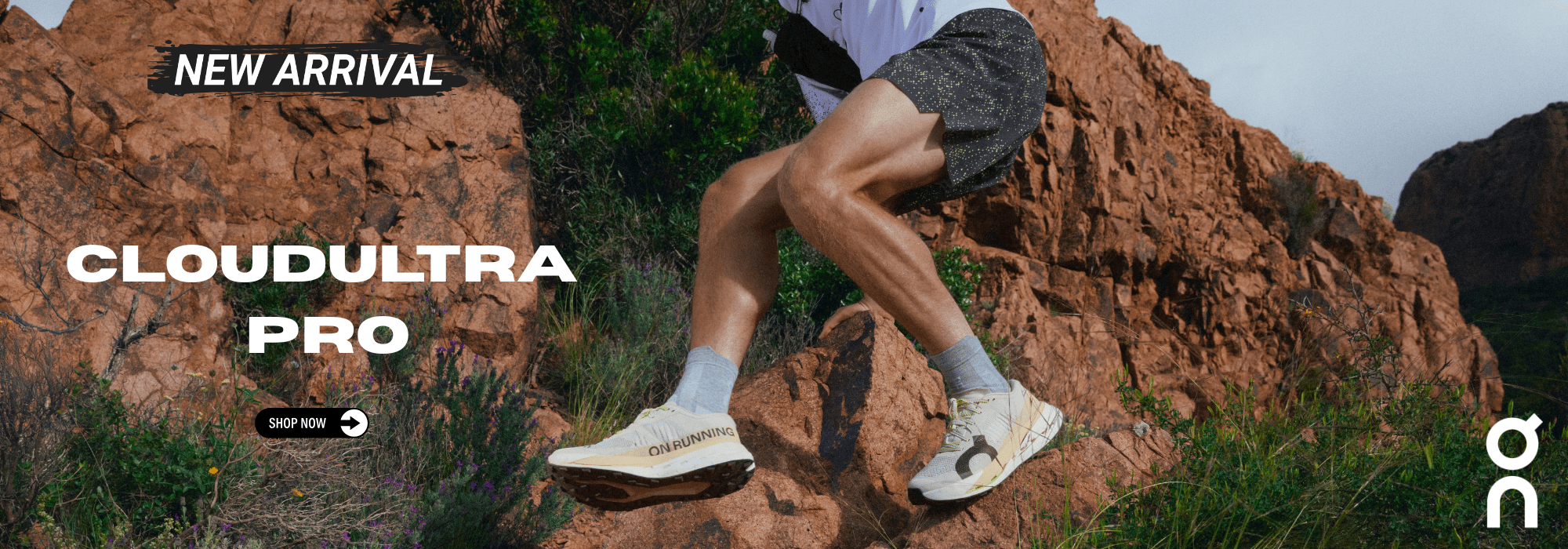 Person climbing a rocky mountain wearing Cloudultra Pro shoes with On brand logo.